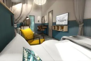 S-Studio Zimmer mit gelbem Stuhl und Fernseher.