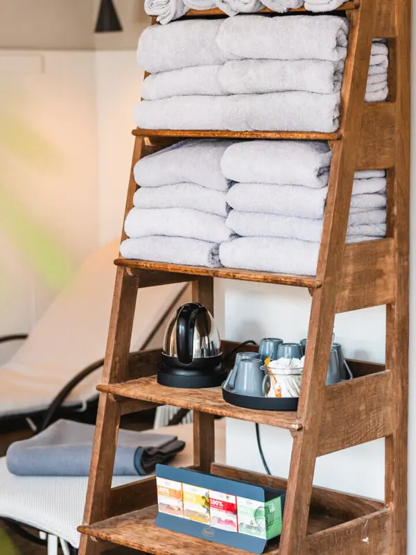 Regal mit Handtüchern Ein Stapel Handtücher auf einem Holzregal.