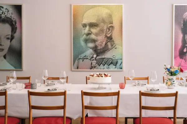 Salon Milano im HENRI Hotel Kitzbühel Ein Tisch mit einem Kuchen und Gläsern darauf.