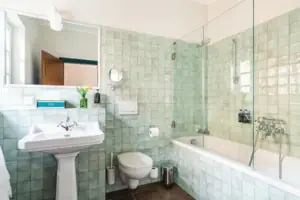 Badezimmer mit Glastür-Dusche und Waschtisch